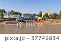 Backhoe dredging the river in the countryside. 37749834