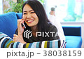 ソファーでくつろぎながら通話する女 38038159