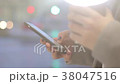 Hands holding a smartphone and a coffee cup on the 38047516