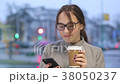 Smiling young female checks social media on her  38050237