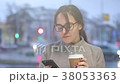 Pretty young girl checks social media on her phone 38053363