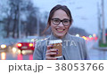 Smiling portrait of young female holding a coffee 38053766