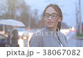 Portrait of smiling girl posing outside the city 38067082
