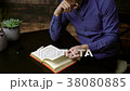 Man reading a hardcover book 38080885