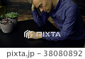 Very sad man at table 38080892