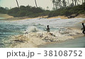 Teenagers boys jumping into wild waves 38108752