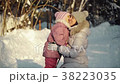 Mom and daughter hug in the suburbs in winter. 38223035