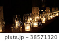 Large group of glass jars with burning candles on  38571320