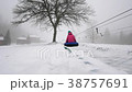 happy girl and mather rides snowtube on snowy 38757691