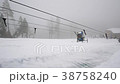 happy girl rides and smiling snowtube on snowy 38758240