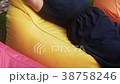 woman relaxes in a bag-chair on a clearing with 38758246