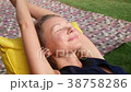 woman relaxes in a bag-chair on a clearing with 38758286