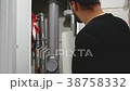 Master builder in hard hat with design drawings at 38758332