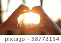 Close up of hands making heart over nature sunset 38772154