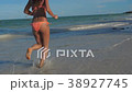 SLOW MOTION Running athletic thin girl sea coast 38927745