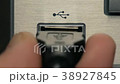 The man connects black USB cable. Close-up	 38927845