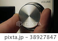 The man adjusts the volume	 38927847