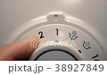 The man selects the washing program by rotating th 38927849