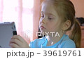 little girl playing on a tablet 39619761