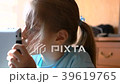 little girl playing on a tablet 39619765