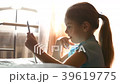 little girl playing on a tablet 39619775