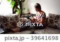 Beautiful girl relaxing on sofa using laptop and 39641698
