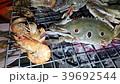 Grilled seafood on the charcoal stove. 39692544