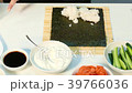 The cook makes a sushi roll. Fast moving. 39766036