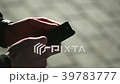 Man is using his smartphone at the street.  39783777