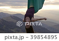Woman in hammock meditating upside down at sunset 39854895