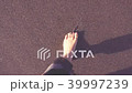 Male feet walking on the beach 39997239