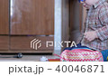 Cute boy in funny glasses draws with both hands on paper at home 40046871
