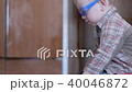 Cute boy in funny glasses draws with both hands on paper at home 40046872