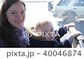A young mother and a boy are riding on a bus. Smile and look at the camera 40046874