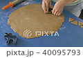 Cutting cookies in shape of christmas tree in dough with cutter, color graded 40095793