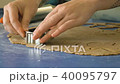Female hands cutting cookies in dough with cutter, closeup FullHD color graded 40095797