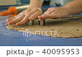Woman gently cutting cookies in dough with cutter, closeup FullHD color graded 40095953
