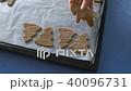 Woman is placing shaped holiday cookies on the oven tray, FullHD color graded 40096731