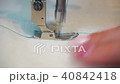 middle-aged woman hand stitching on beige fabric sewing machine 40842418
