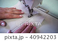 professional sewing machine, middle-aged woman's hands 40942203