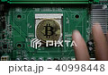The man's hand puts the bitcoins in a column on the motherboard. Crypto currency Bitcoin - BTC - 40998448