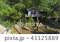 Aerial. Small white bungalow with hammock on the g 41125889