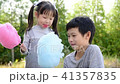 Little girl and boy eating cotton candy in park 41357835