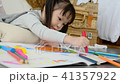 Little girl drawing picture by crayon and pencil 41357922