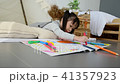 Little girl drawing picture by crayon and pencil 41357923
