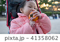 Little asian girl is having a persimmon for her sn 41358062
