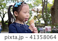 little Asian girl eating green tea icecream  41358064