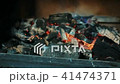 Young employee is touching coals in smoker oven in kitchen indoors. 41474371