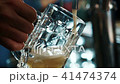 In the bar, close-up, a light beer is poured into the mug. 41474374