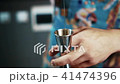 Close-up of a barman measures alcohol with a jigger. 41474396